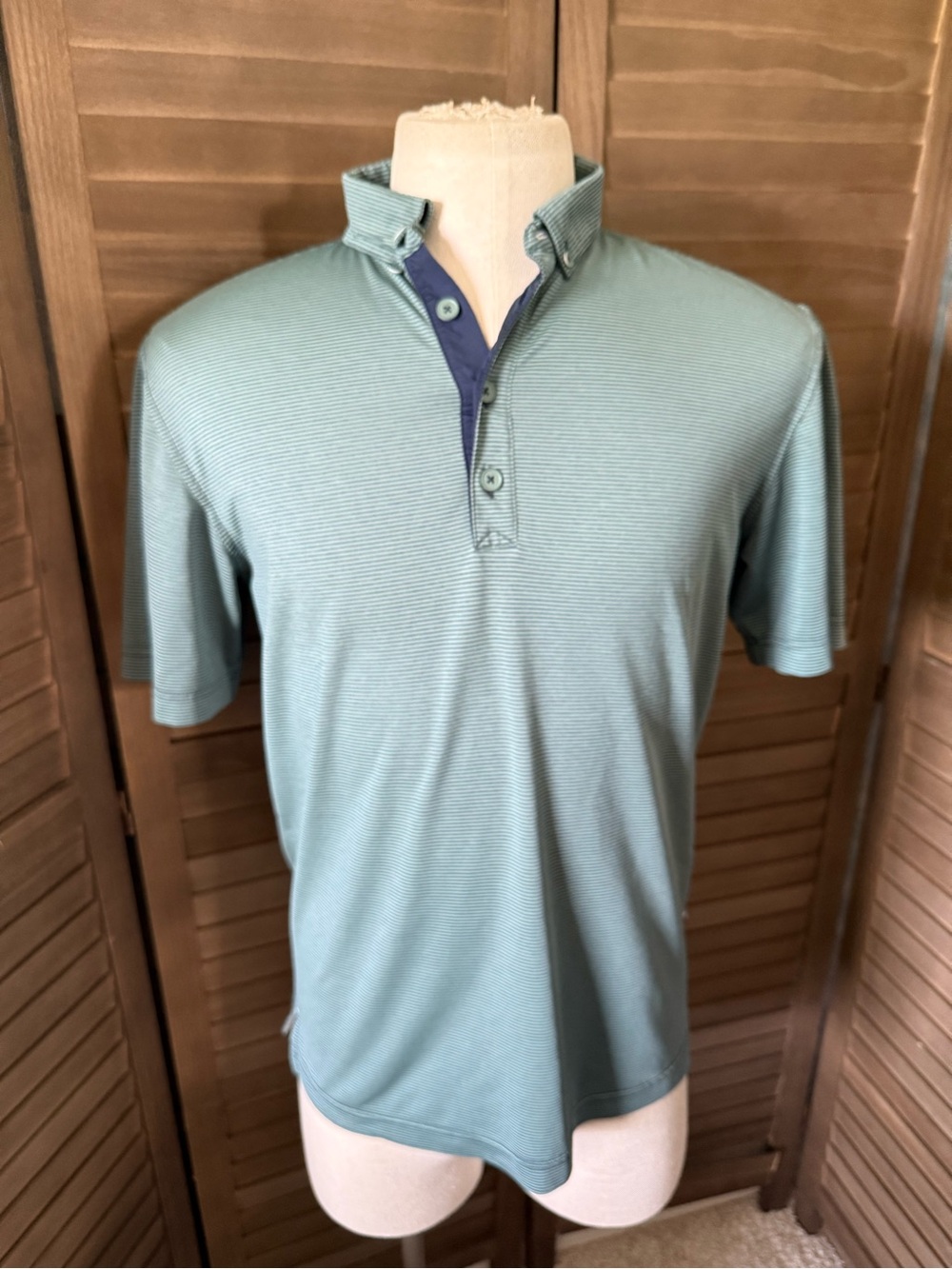 Adidas’ premium quality Adipure golf polo in thin alternating green stripes